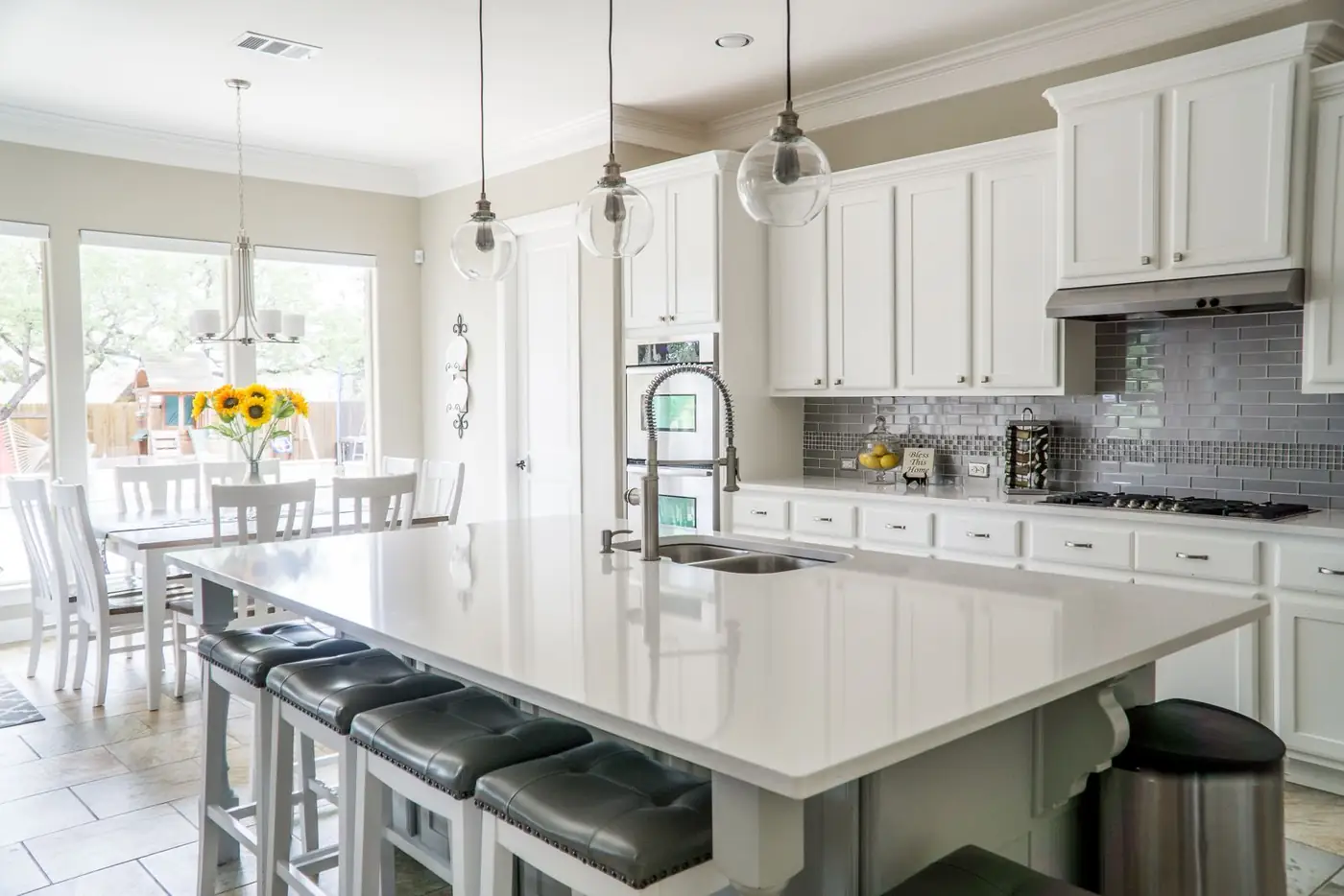 Illustrative photo of a bright kitchen with white cabinetry and an island. Not a Pure Kitchens installation.