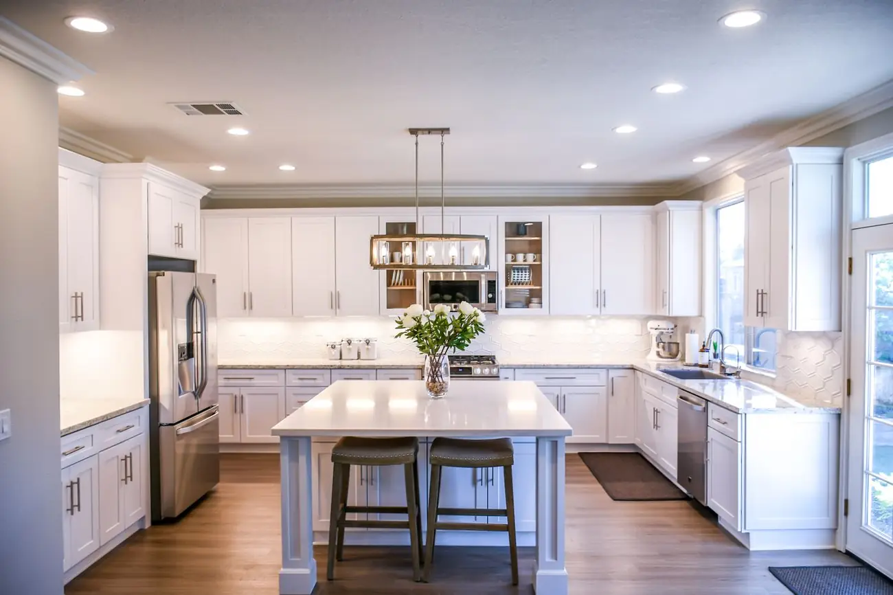 Illustrative photo of a white kitchen with an island. Not a Pure Kitchens installation.